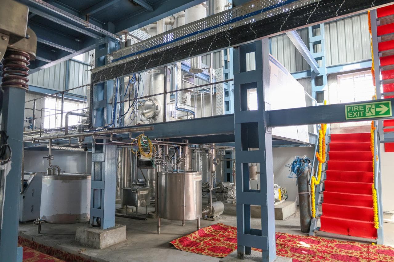 Processing hall with mezzanine and red staircase